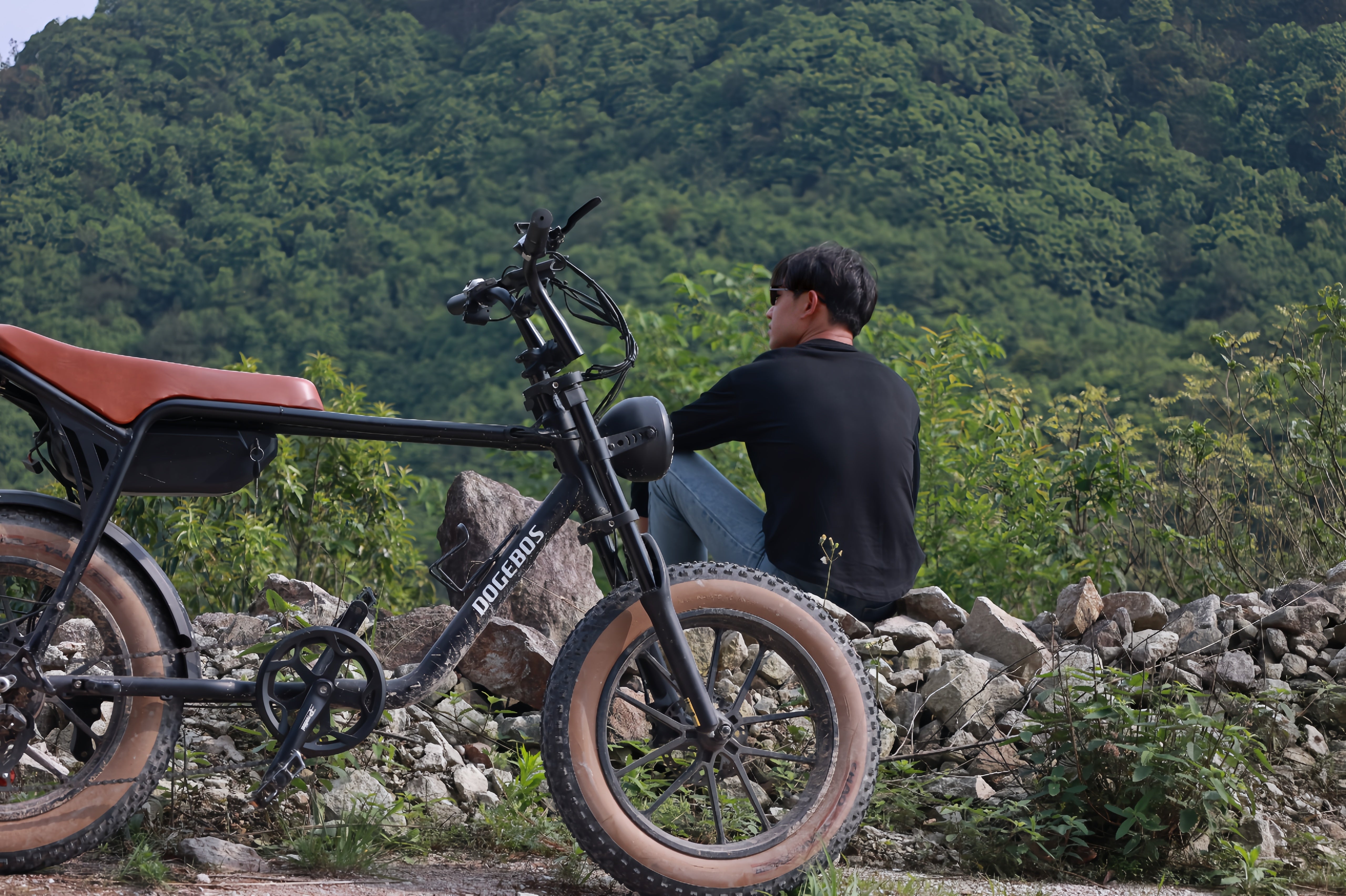Front view of E3 fat tire bike and model looking at mountain landscapese